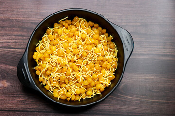 A close up of traditional Indian snacks. crispy savory sev and sweet golden boondi served together. Perfect flavors in authentic Indian namkeen and festive treats. sev bundi.