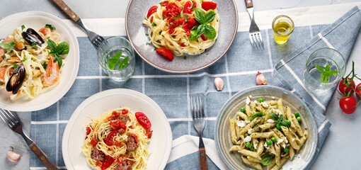 Plates of pastas with different kinds of sauces.