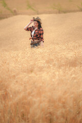 Cowgirl smiling in wheat field children’s joy nature scene countryside view