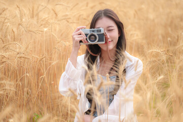 Young woman photographer smiling while holding a camera