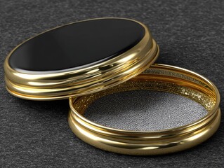 Gold-rimmed, black-topped, circular container, slightly ajar, rests on dark surface