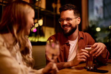 Smiling Friends Enjoying Drinks Together at a Cozy Indoor Cafe Setting