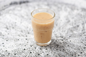 Pineapple coconut smoothie on bright background. Soft focus. Copy space.	