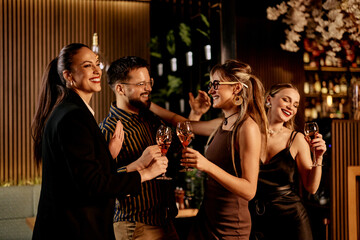 Group of Friends Enjoying Drinks and Conversation at a Stylish Indoor Gathering