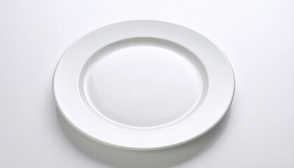 Simple white ceramic plate on a white background, perfect for minimalist dining and kitchenware themes.