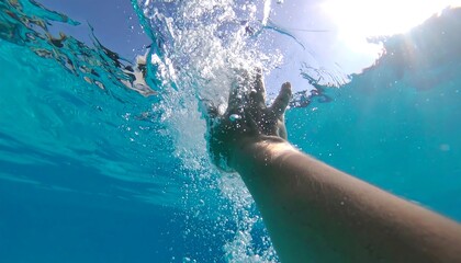 Underwater View of Swimmer Arm Breaking Water Surface with Splash Effect