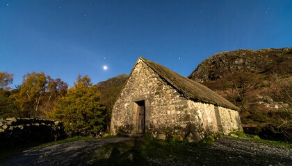 Rustic stone cottage under a moonlit sky