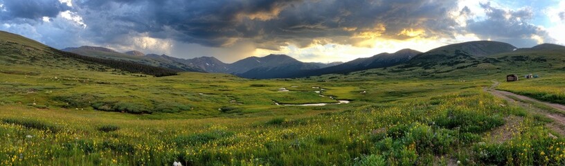 Mountain meadow at sunset, dramatic clouds