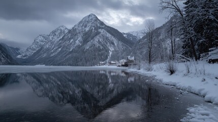 Snowy mountain lake reflecting a village