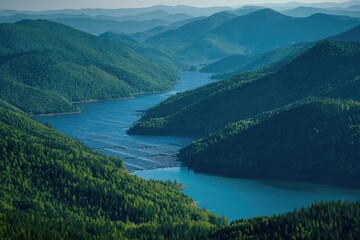 Misty mountain range with a vibrant blue reservoir