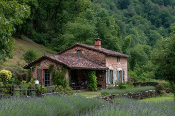 Obraz premium Rustic stone house nestled in a valley, surrounded by lavender