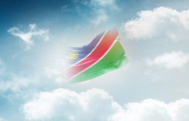 Namibia flag waving light background hidden in the sky.