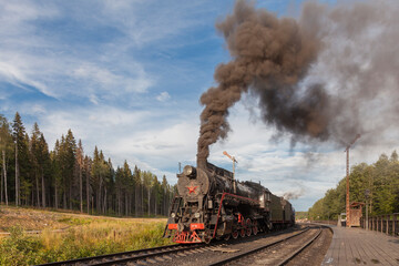 An old steam locomotive stands at a railway station