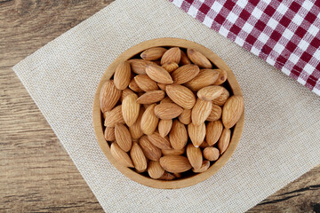 Fresh almonds in wooden bowl 