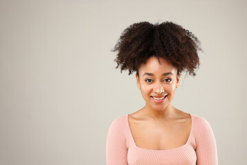 Portrait of beautiful Brazilian woman on gray background, space for text
