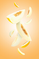 Cut fresh ripe melons swirling in air against beige gradient background