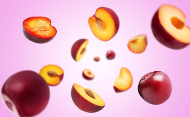 Fresh ripe plums swirling in air against violet gradient background