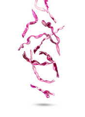 Shredded fresh red cabbage falling on white background
