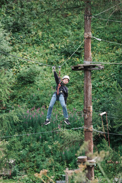 boy hanging on a zip wire in the mountains in Switzerland