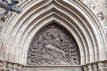 Relief Pieta above Door of Mercy (Porta de la Pietat) to Gothic Barcelona Cathedra, Barcelona, Spain