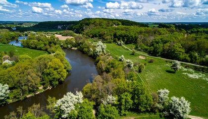 Panoramic view of a river winding through lush greenery