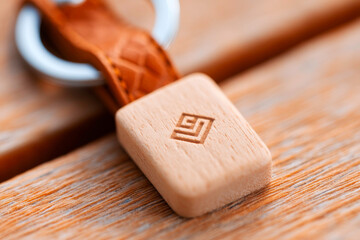 Charming closeup of a personalized wooden and leather keychain featuring a custom engraved design