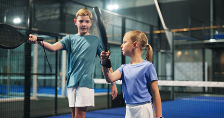 Padel, learning and kids with racket on indoor court for sports workout, exercise and training....