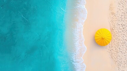 Aerial view of a serene beach with vibrant turquoise water, soft sand, and a bright yellow umbrella for shade.