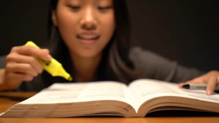 An Asian student highlights a textbook as an animated yellow data graph visualizes the learning process - Powered by Adobe