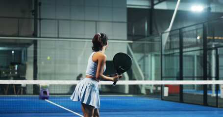 Padel tennis, athlete and woman with racket, court or practice for tournament, wellness or...