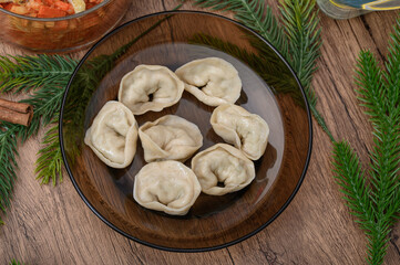 Fototapeta premium Cooked Christmas Eve dumplings stuffed with mushrooms placed on a plate on the holiday table