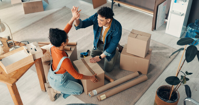 Team, boxes and people with high five for delivery success, sealing parcel and ready for courier. Above, package support and business partners in office for shipping, ecommerce and sales achievement