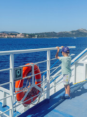 Child Enjoying Scenic Ferry Ride with Life Buoy