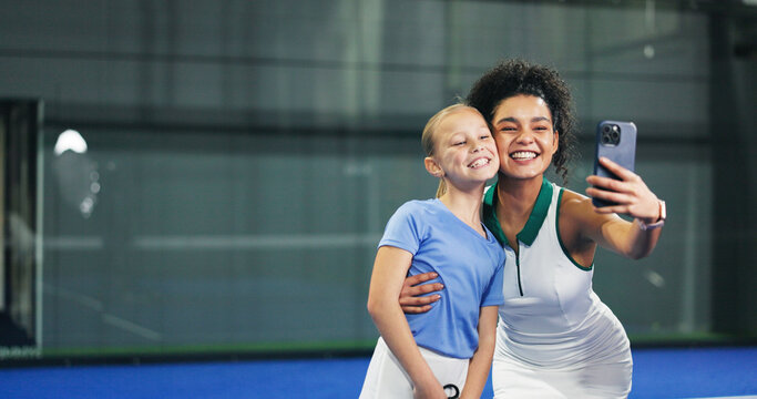 Padel, selfie and smile of coach with girl in sports venue for memories, practice or training. Fitness, hug or photograph with child and personal trainer woman on space for development or exercise