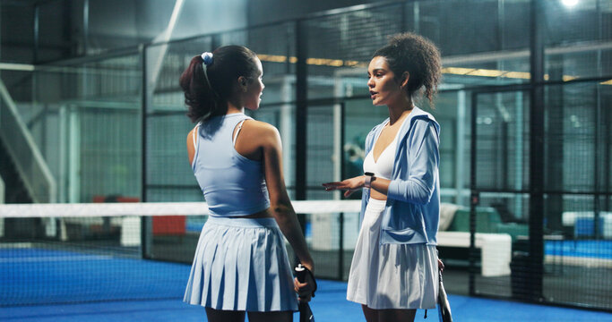 Athlete, people and talk on court for padel training, sports discussion and match feedback. Women, friends and conversation for tennis practice, game strategy and technique tips of competition advice