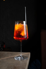 Refreshing cocktail rests on a table, showcasing vibrant colors and ice, inviting conversation