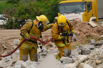 Firefighters are working together to extinguish a fire using water during a fire.