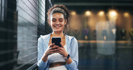 Athlete, woman and happy with phone at tennis court for practice break, sport and online browsing....