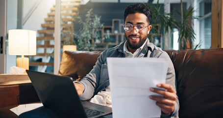 Happy man, laptop and sofa with documents for finance, budget planning or expenses in home. Male...