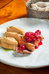 Delicious gourmet dish with smooth textures and bright, tangy toppings for a unique taste