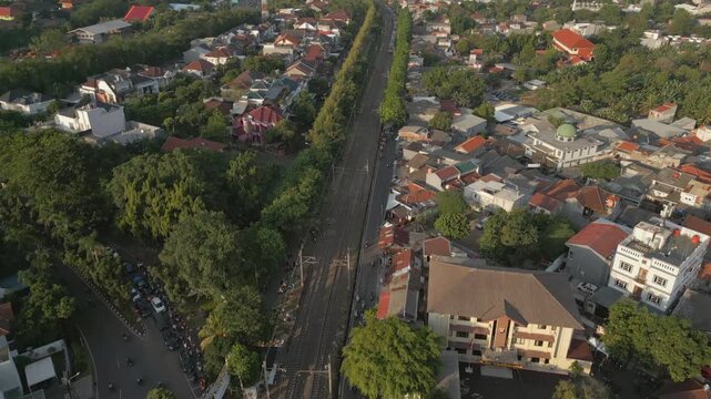 Bintaro Neighborhood At Sunset Jakarta Indonesia Train And City In Distance Drone Pan Up 4K 60FPS
