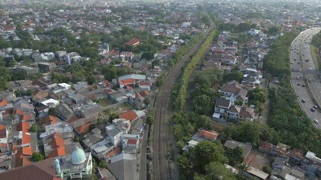Railway Line And Motorway Slice Through Bintaro Neighborhood In Jakarta Indonesia 4K 60FPS