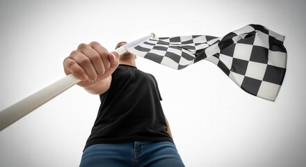 Low angle view of person holding checkered racing flag against sky