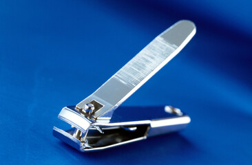 nail clipper isolated on blue background 
