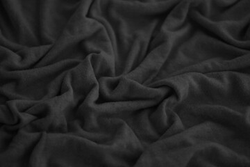Texture of Dark grey crumpled textile cloth part with small folds