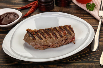 Grilled beef striploin steak with sauce