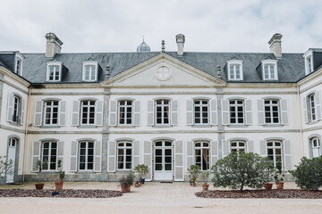 Obraz premium Exterior side view of French château wedding venue with terrace and shutters