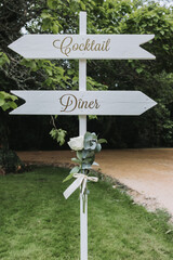 Outdoor wedding cocktail setup with tables under trees in château garden