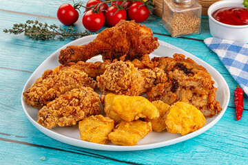 Golden crispy fried chicken mix - wings, drumsticks, nuggets and strips
