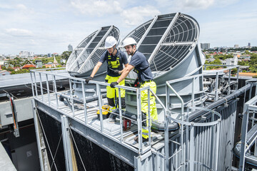 Professional worker servicing HVAC building cooling tower, Industry air conditioner service